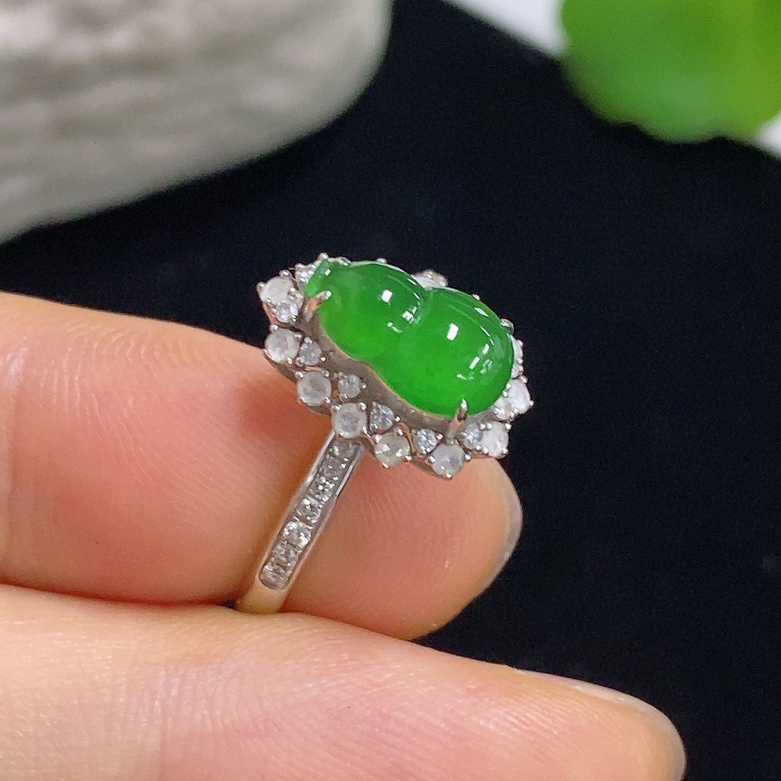 Jadeite gourd inlay ring with 18K gold and diamond accents, featuring detailed craftsmanship and elegant design.