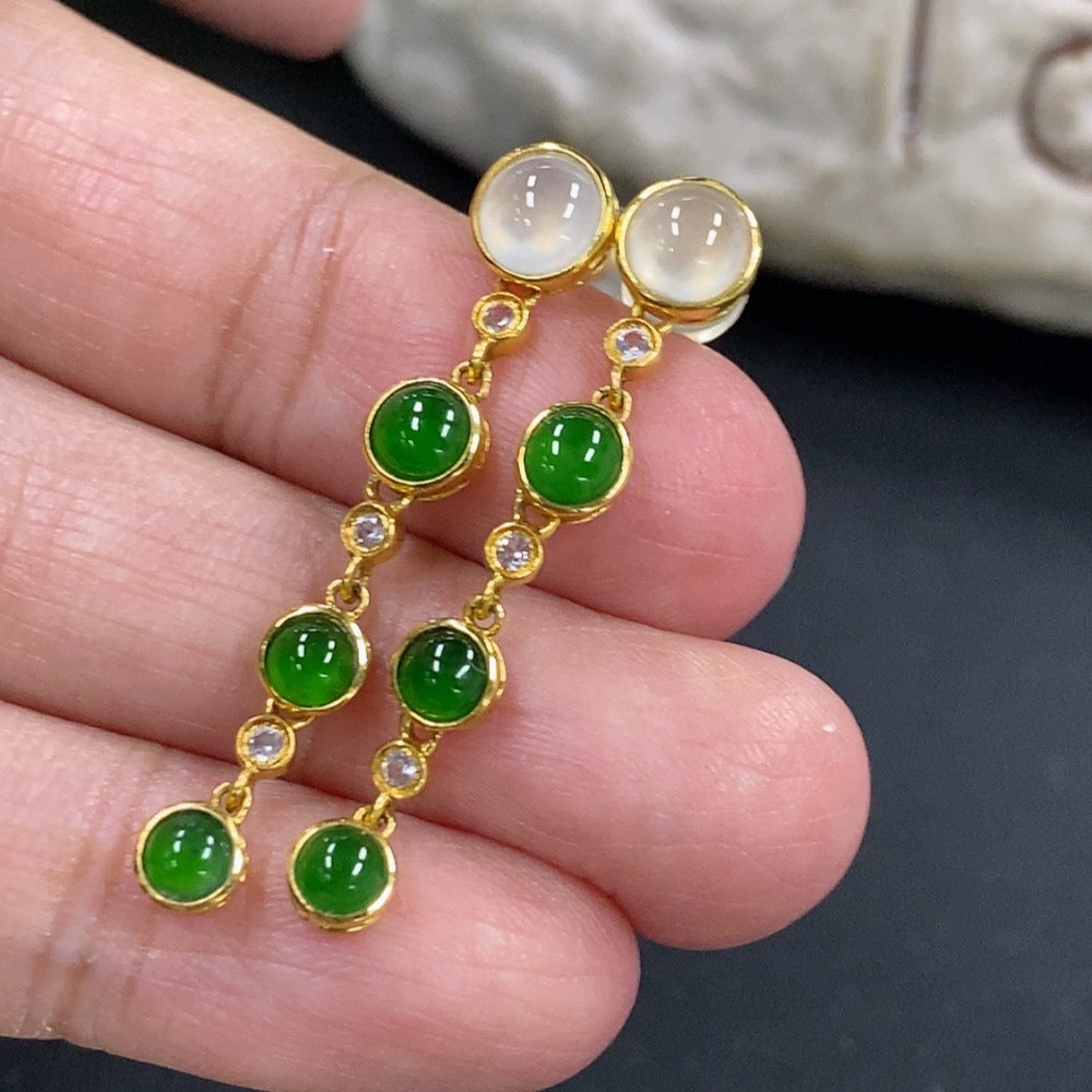 HKHQ jadeite cabochon earrings in 18K gold with a smooth, polished finish, showcasing elegant jewelry design.