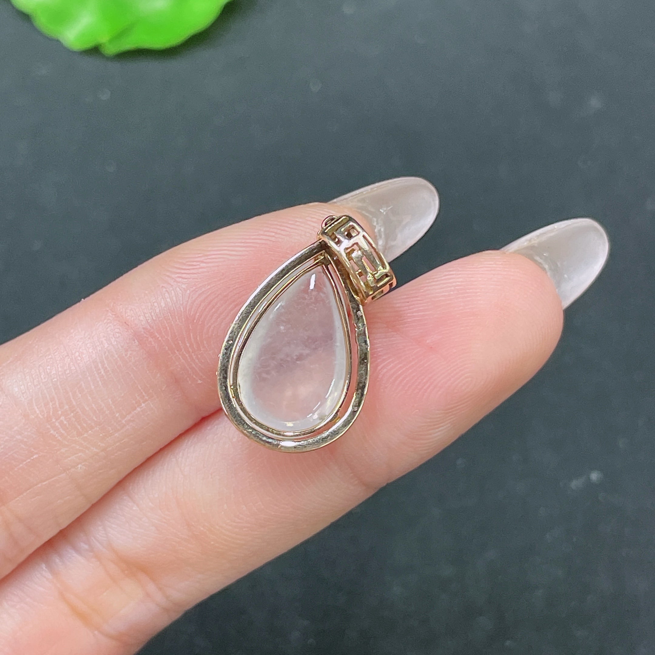 Huiliu Jadeite teardrop inlay pendant with smooth jade surface and polished finish, showcasing elegant craftsmanship.