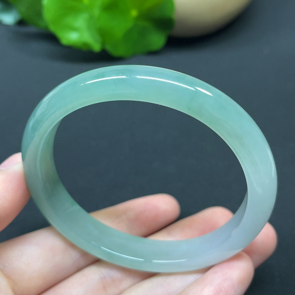 HKHQ jadeite oval bangle in size 55.6 with 35.37g, showcasing smooth, polished jadeite with a sleek oval shape.