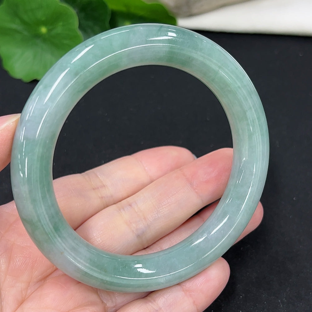 HKHQ jadeite round bangle, size 57.7, weighs 68.6g, showcasing smooth, polished green jadeite bracelet with natural variations.