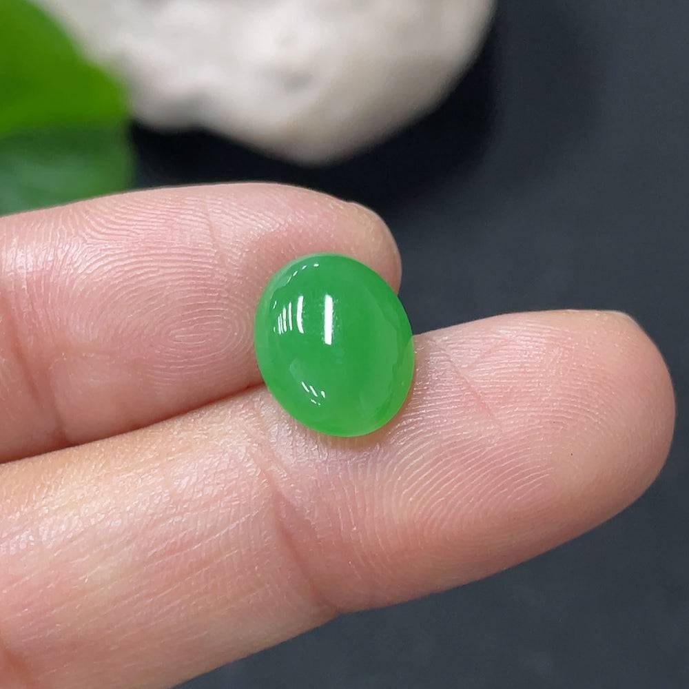 Jadeite cabochon from HUILIU HQ, approximately 0.67g, smooth polished jade gemstone with a rounded, domed shape.