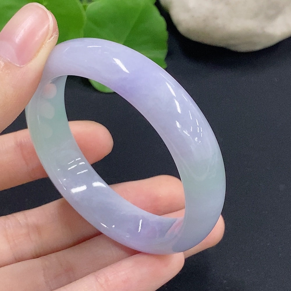 Jadeite oval bangle bracelet by HKHQ featuring a smooth, polished surface in size 50.2 with a weight of 33.7g.