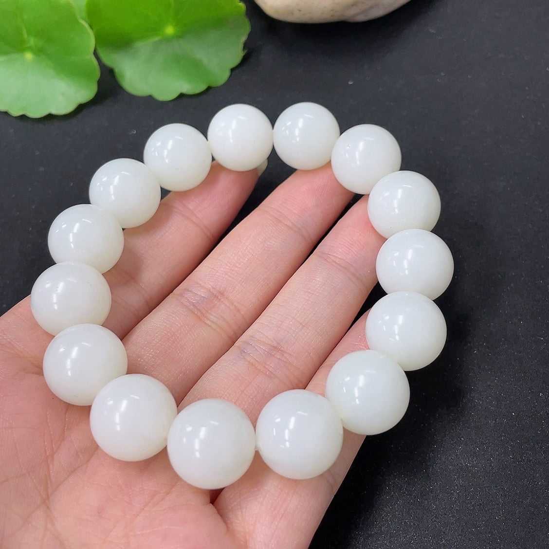 Hetian Jade bracelet by HKHQ with 13.6mm beads, weighing approximately 62g, displayed on a neutral background.