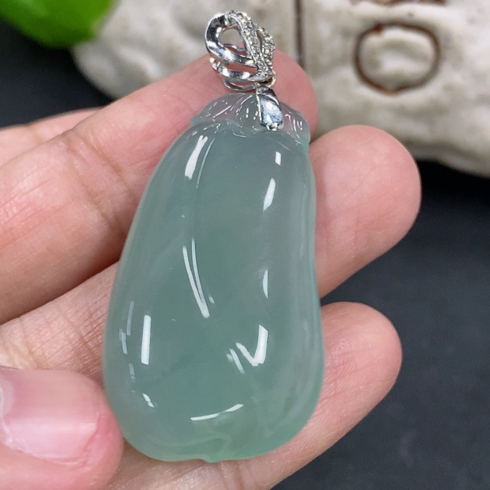 Jadeite pendant featuring a blessing melon design with 18K gold accents and diamond embellishments, on a necklace chain.