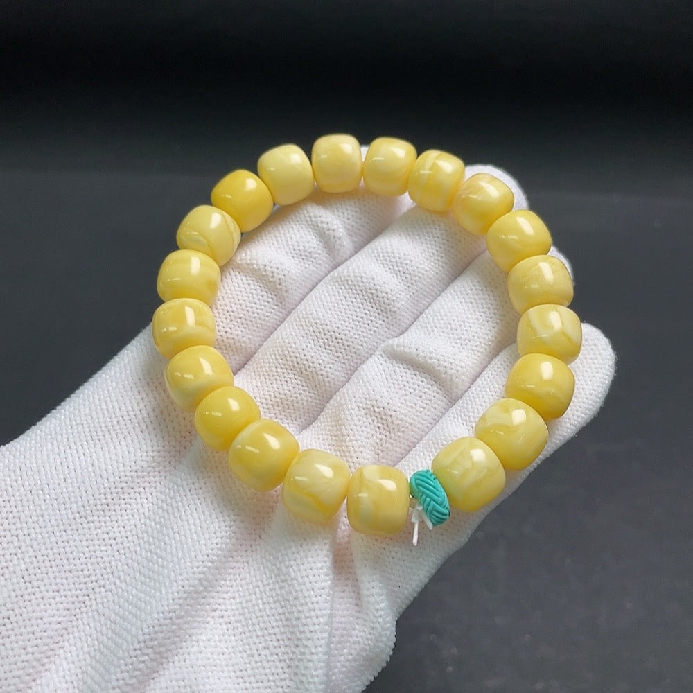 Amber beeswax bracelet with turquoise accents, showing partial repairs, weighs about 14.1g, with 10.4mm beads, by HUILIU HQ.
