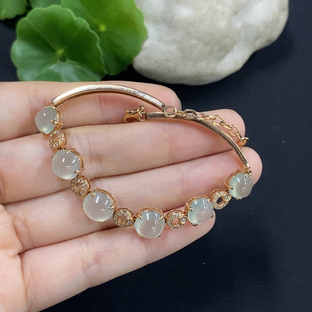 Huiliu Jadeite cabochon bracelet set with diamond accents, featuring polished green jade stones and intricate design details.