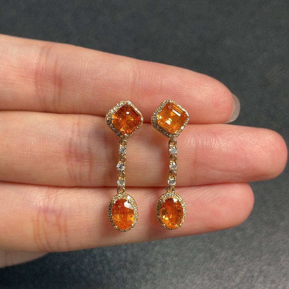 Huiliu Garnet earrings with diamond accents, featuring deep red gemstones and sparkling details in a polished jewelry setting.