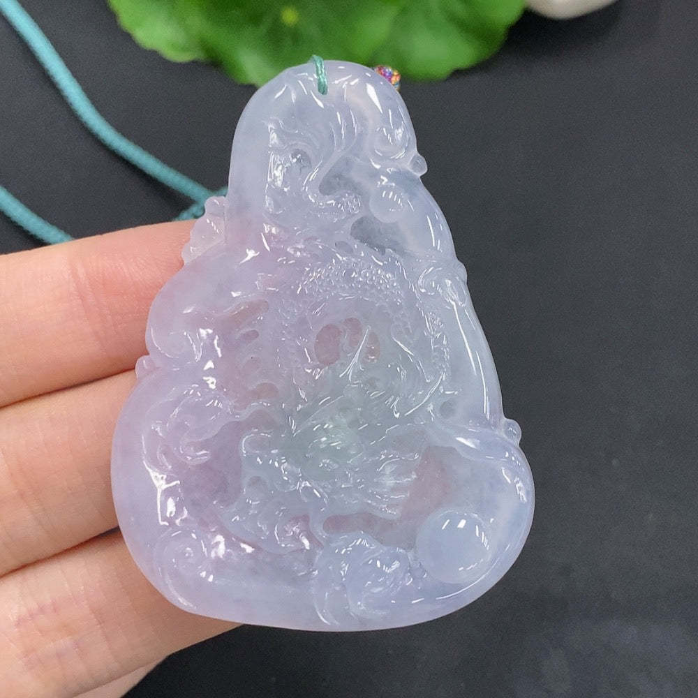 Huiliu Jadeite Dragon Pendant depicting a soaring dragon design, crafted from green jadeite, hanging from a cord.