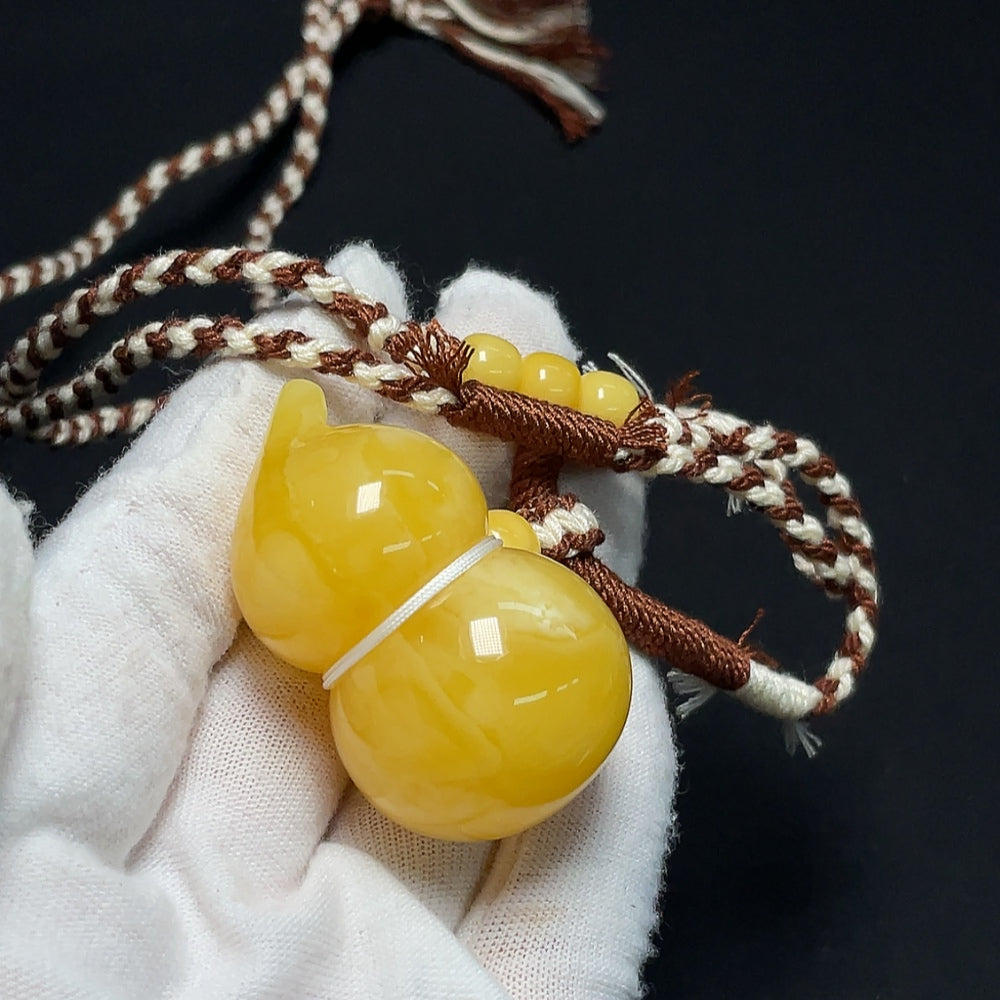 Amber Beeswax Pendant necklace by HKHQ featuring a natural amber beeswax pendant on a delicate chain.