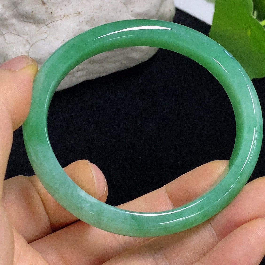 HKHQ jadeite oval bangle in size 56.2 with a weight of 38.3g, showcasing smooth, polished green jadeite bracelet design.