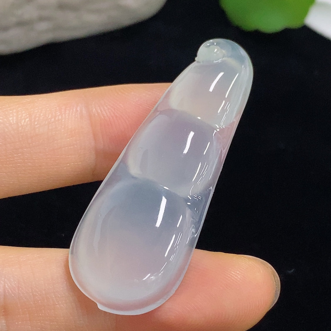 Jadeite pendant with Fu Dou design, weighing approximately 9.8g, crafted by HKHQ, featuring a smooth, polished green jade surface.