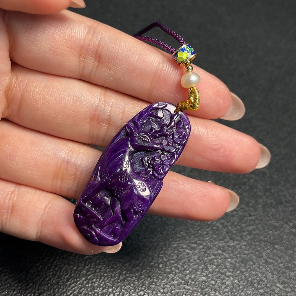 Sugilite pendant with other mineral components, total weight approximately 11.73g including rope, non-gold