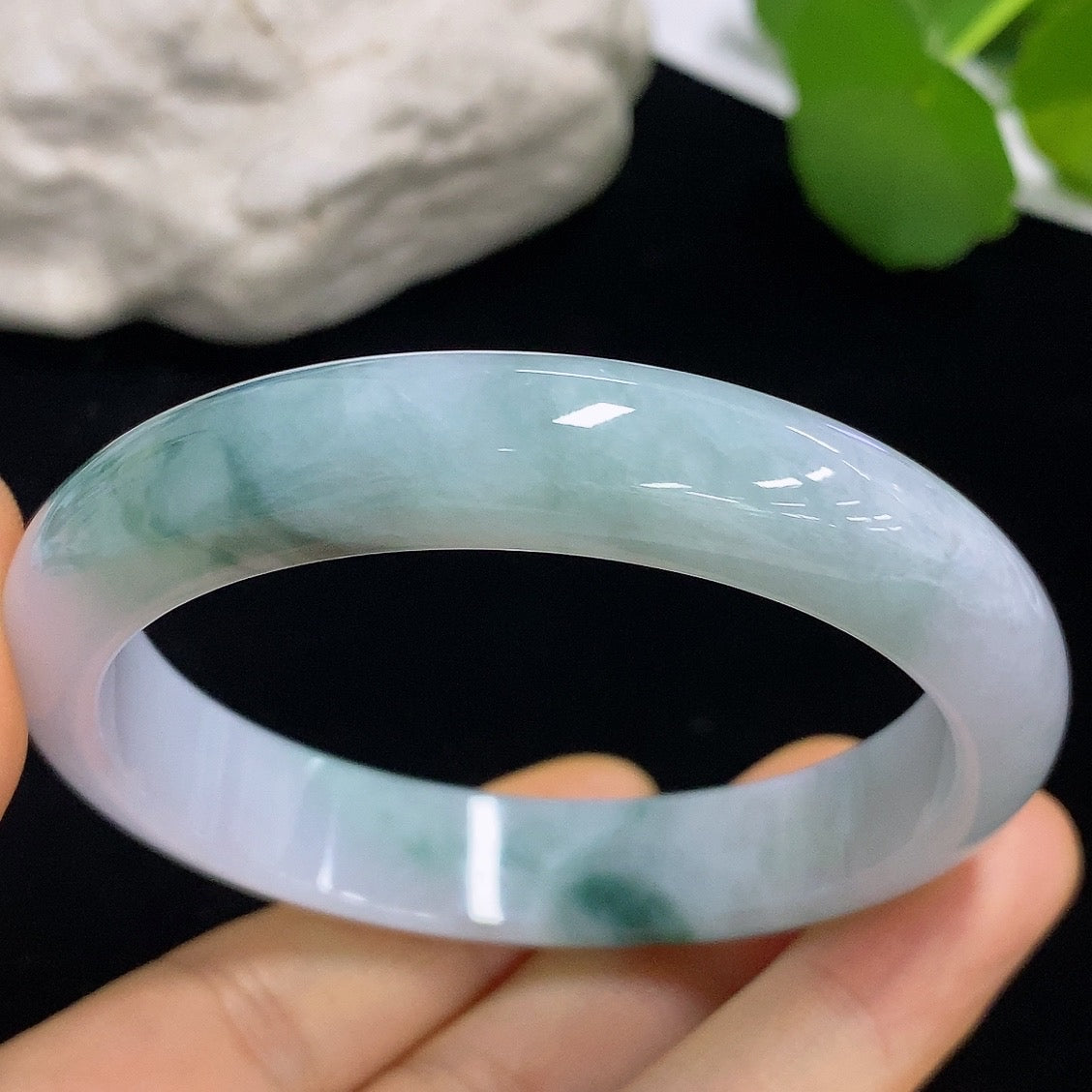 HKHQ jadeite round bangle in size 57.3 with approximate weight of 50.05g, showcasing smooth, polished green jade surface.