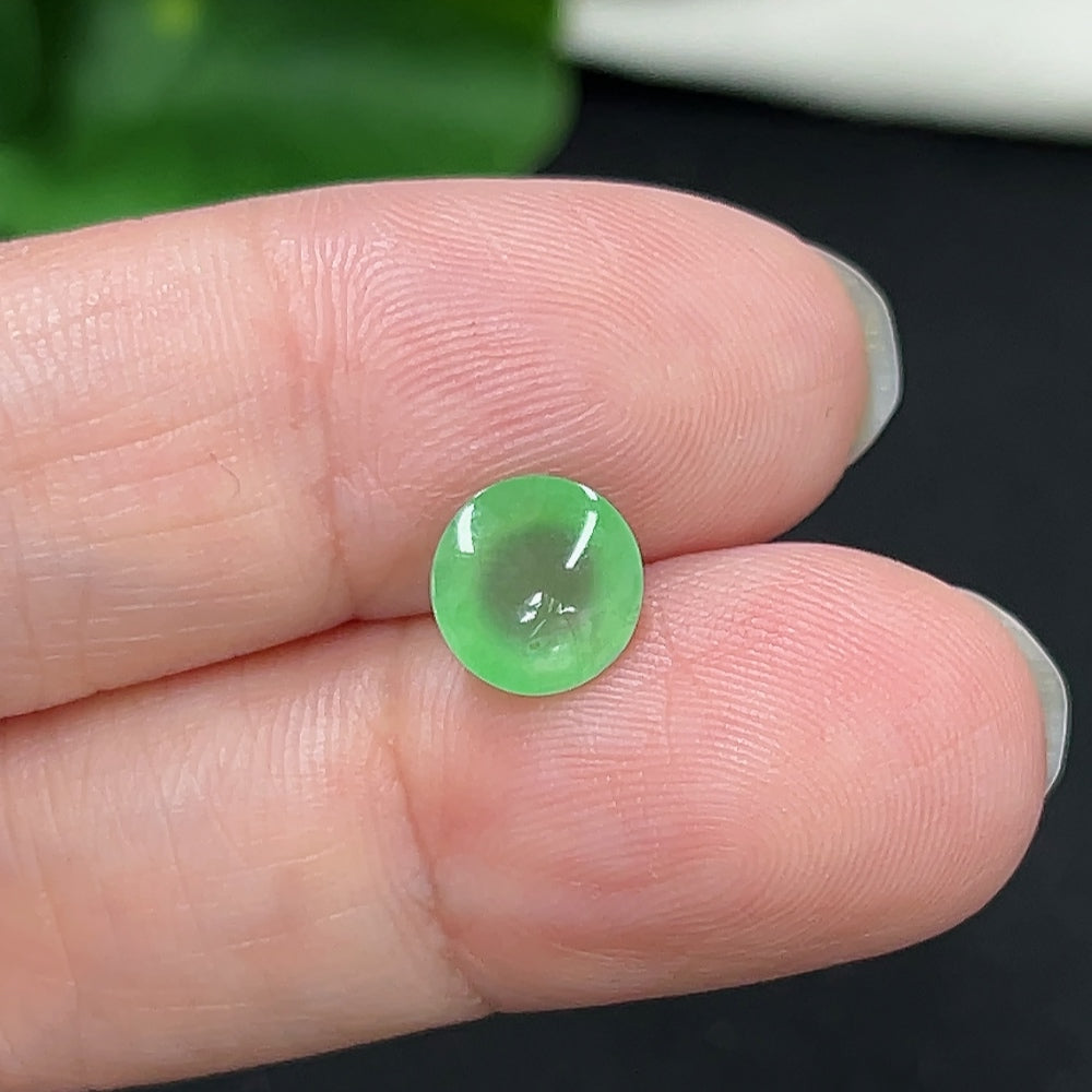 Small jadeite cabochon jewelry piece with a smooth, polished surface, weighing approximately 0.3g, from HKHQ.