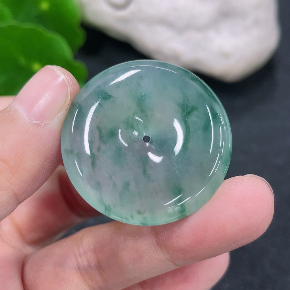 Jadeite pendant with peace knot design, weighing approximately 11.18g, crafted by HKHQ, featuring a smooth, polished jade surface.