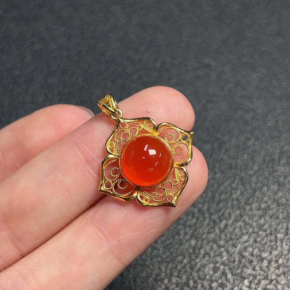 Red Agate gemstone pendant from HUILIU HQ featuring a polished, oval-shaped red agate stone on a silver chain.