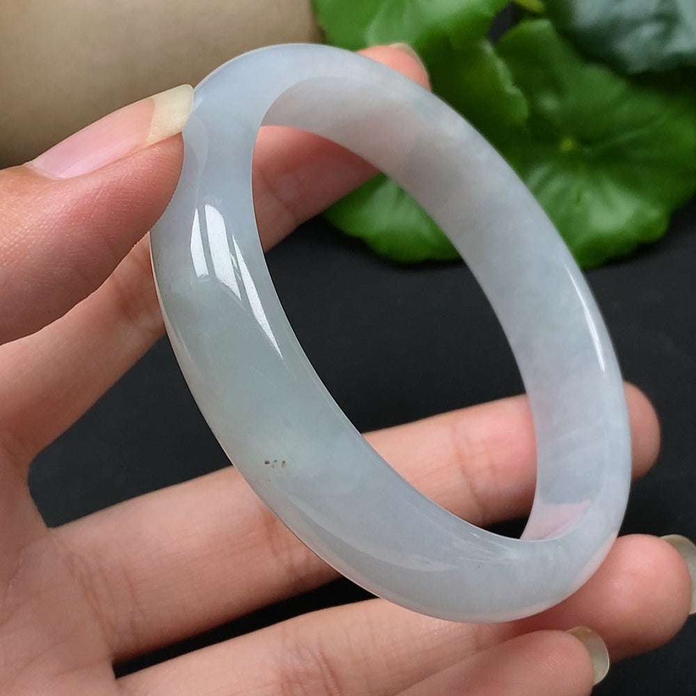HKHQ Jadeite round bangle in size 56.5, showcasing smooth, polished green jade with a glossy finish and detailed craftsmanship.