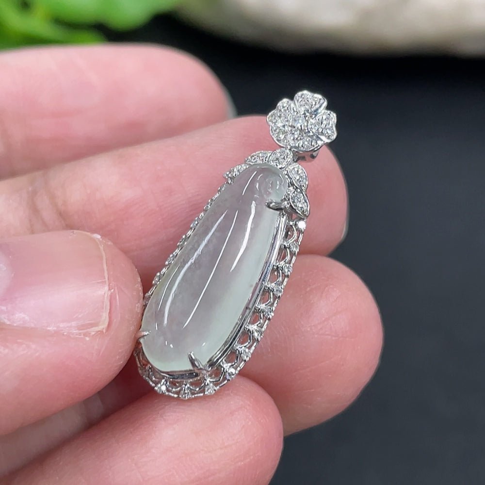 Jadeite blessing melon pendant set in 18K gold with diamonds, weighing approximately 2 grams, displayed against a neutral background.