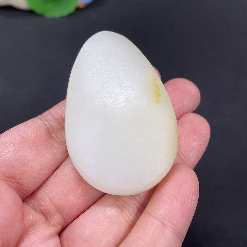 Huiliu certified Hetian jade Guanyin pendant with undetermined skin tone, detailed carving, featuring smooth polished surface.