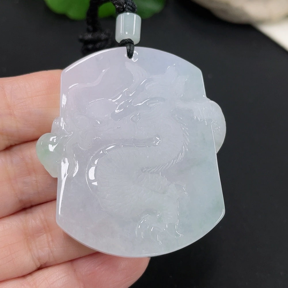 Jadeite dragon pendant with detailed carving, hanging on a rope, weighing approximately 34.52 grams, by HUILIU HQ.