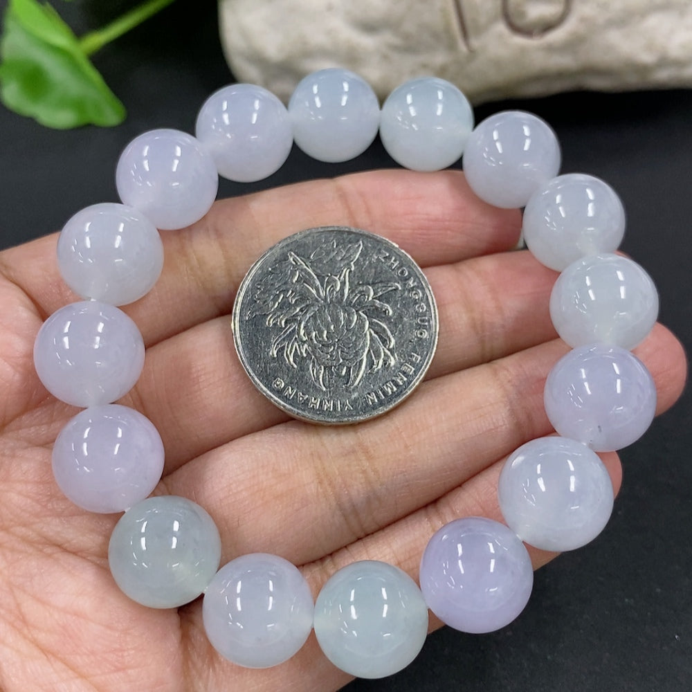 HKHQ jadeite bracelet featuring 12mm beads with a total weight of 49.7g, showcasing smooth, polished jadeite stones.
