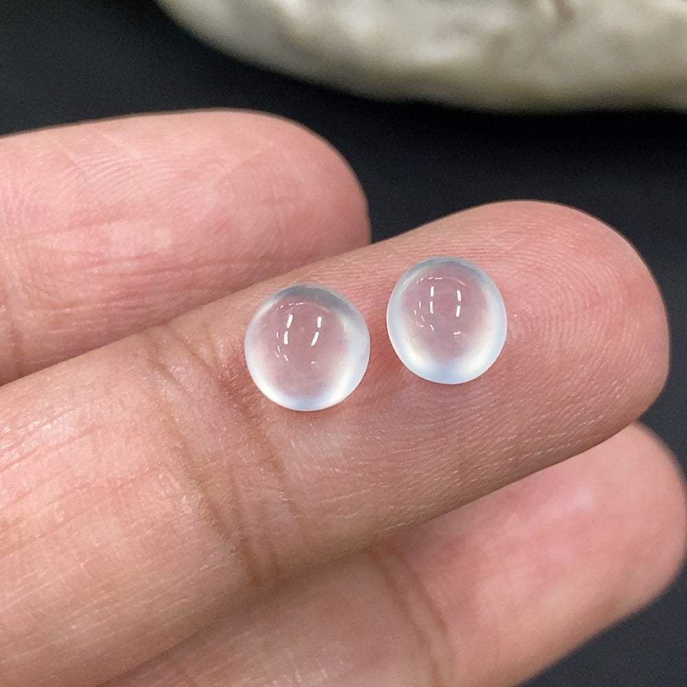 Jadeite cabochon jewelry piece from HKHQ, weighing 0.49g, showcasing smooth, polished green stone with natural variations.