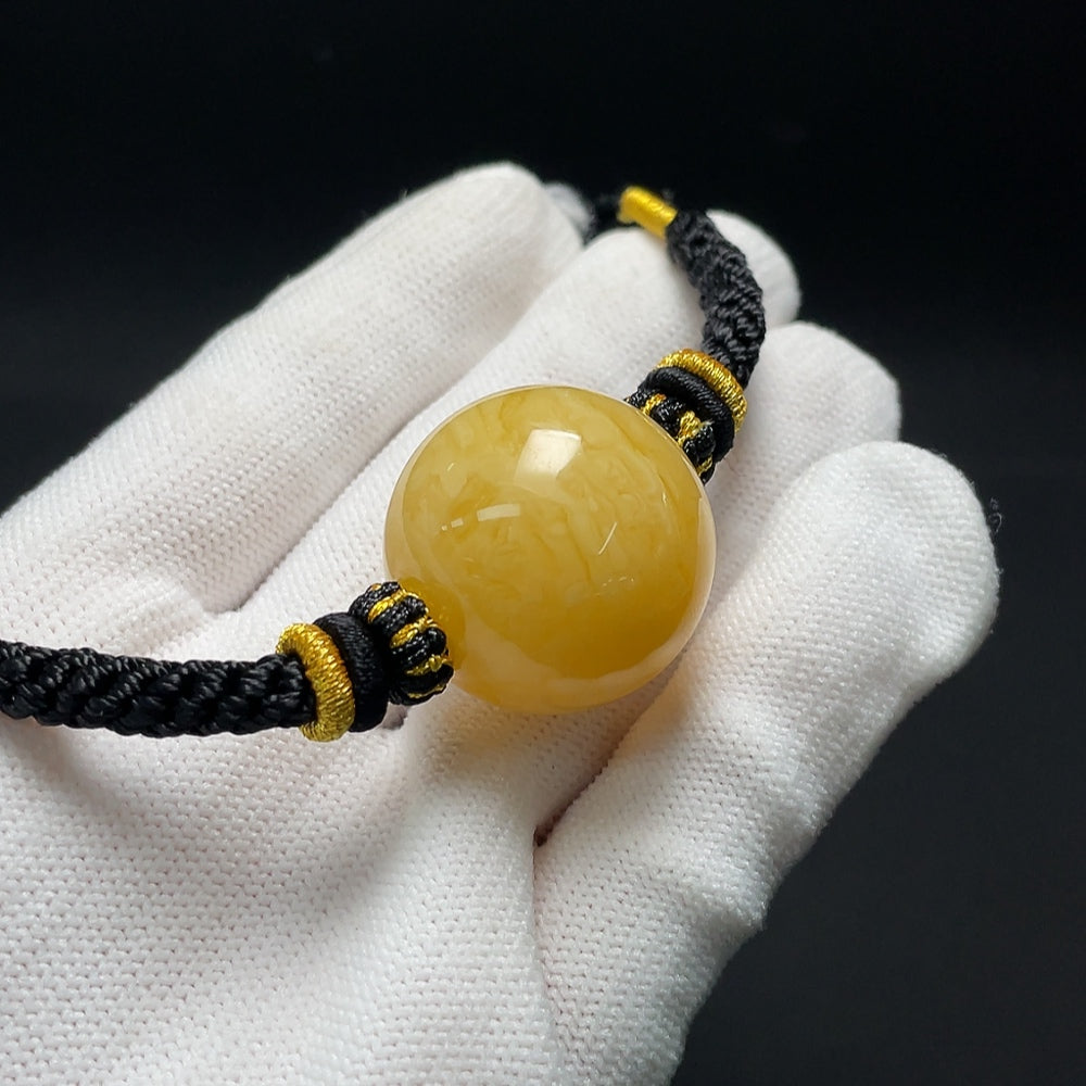 Amber beeswax pendant necklace with cord, weighs 14.39g and measures about 25.2mm, from HKHQ.