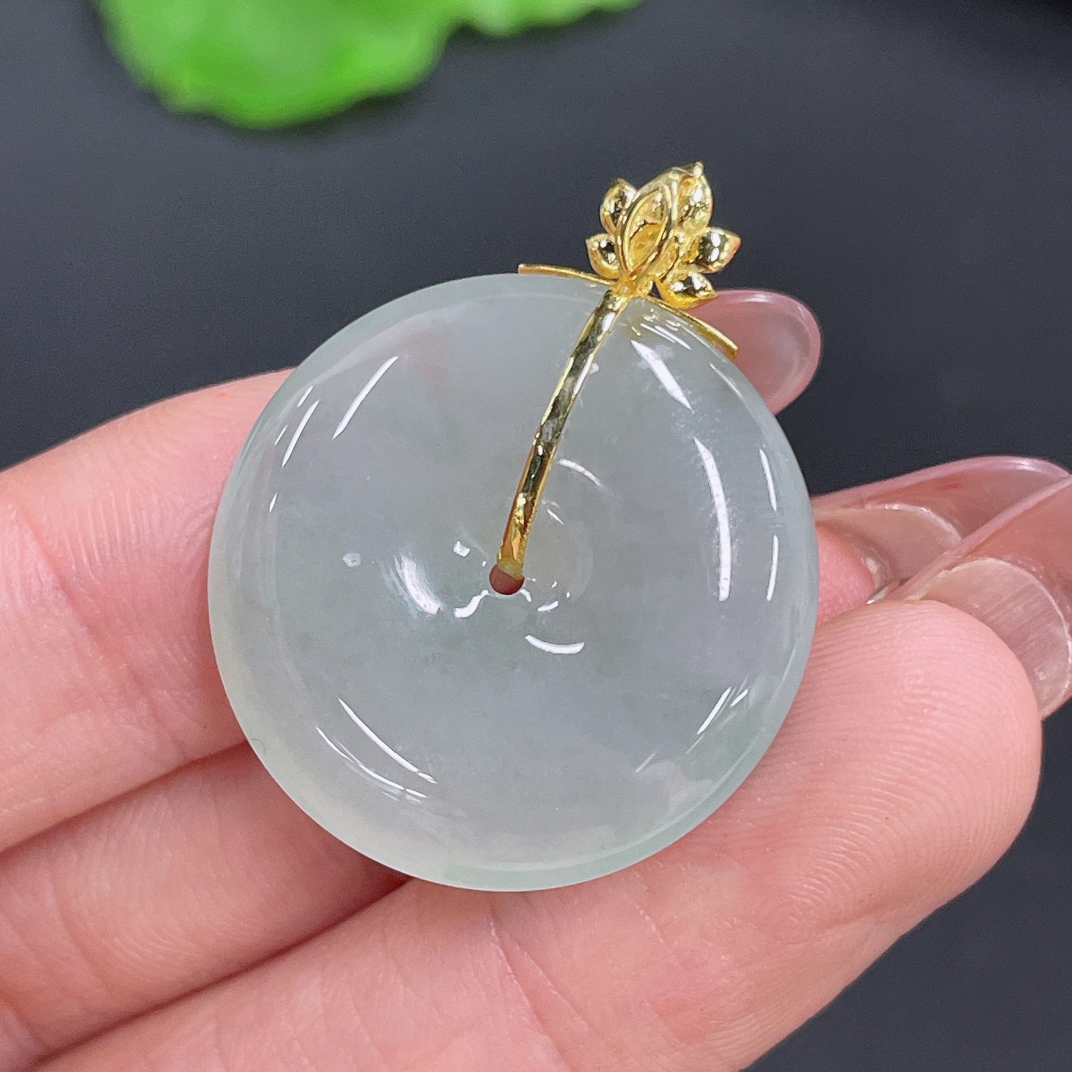 Huiliu Jadeite Peace Knot Pendant featuring a polished jade pendant with intricate knot design on a cord.