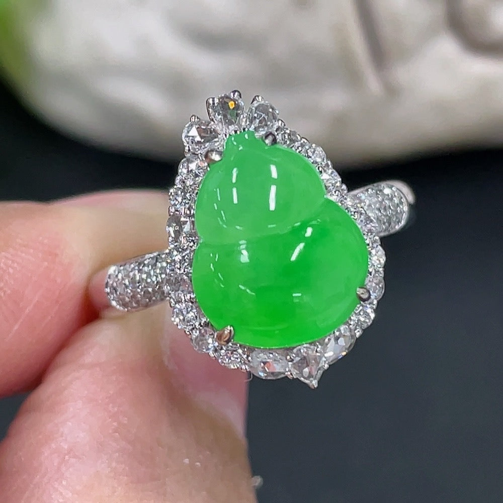 Jadeite gourd inlaid ring with 18K gold setting and diamond accents, showcasing elegant craftsmanship and intricate design.