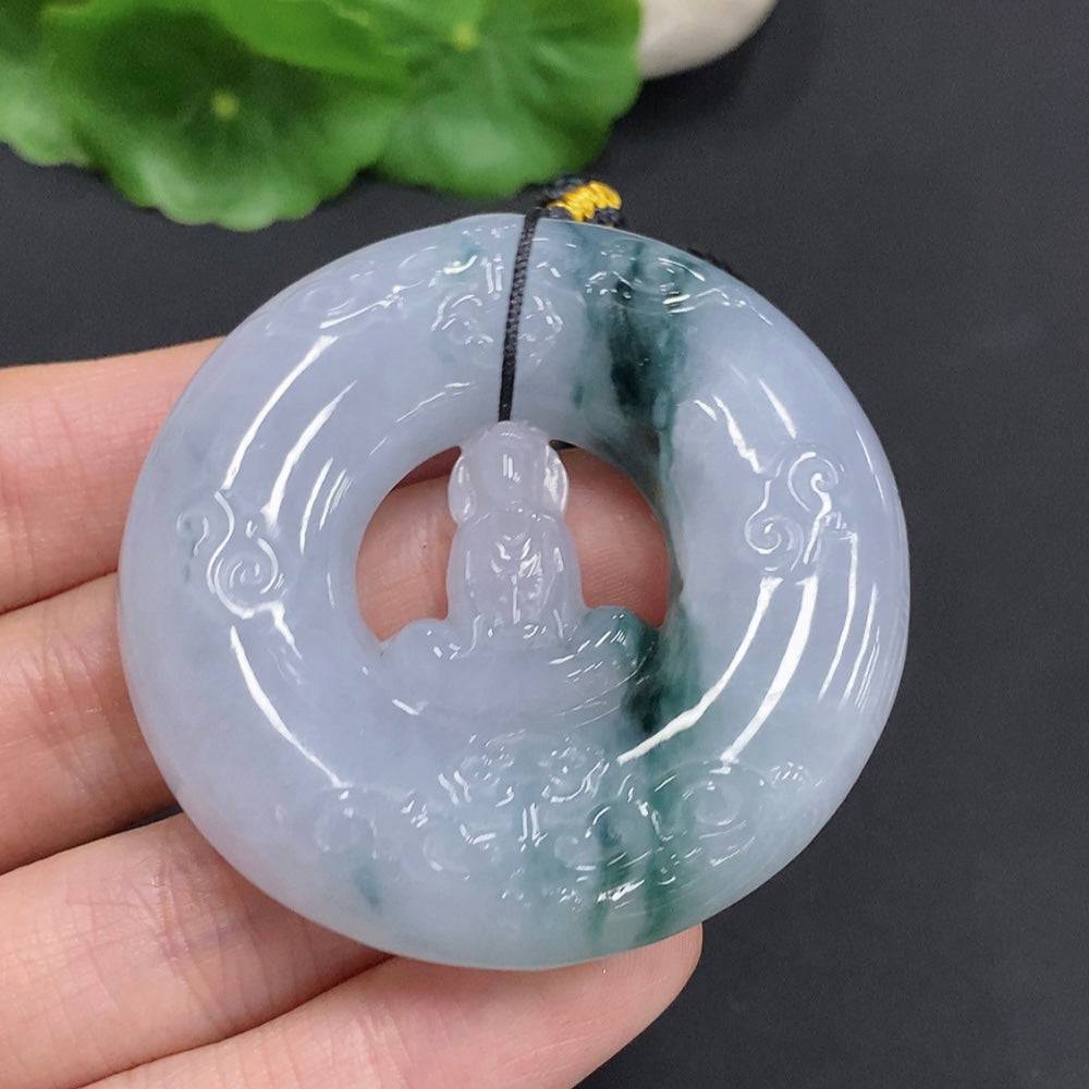 Huiliu Jadeite Enlightenment Pendant hanging on a cord, showcasing smooth, polished green jade with natural variations and craftsmanship.