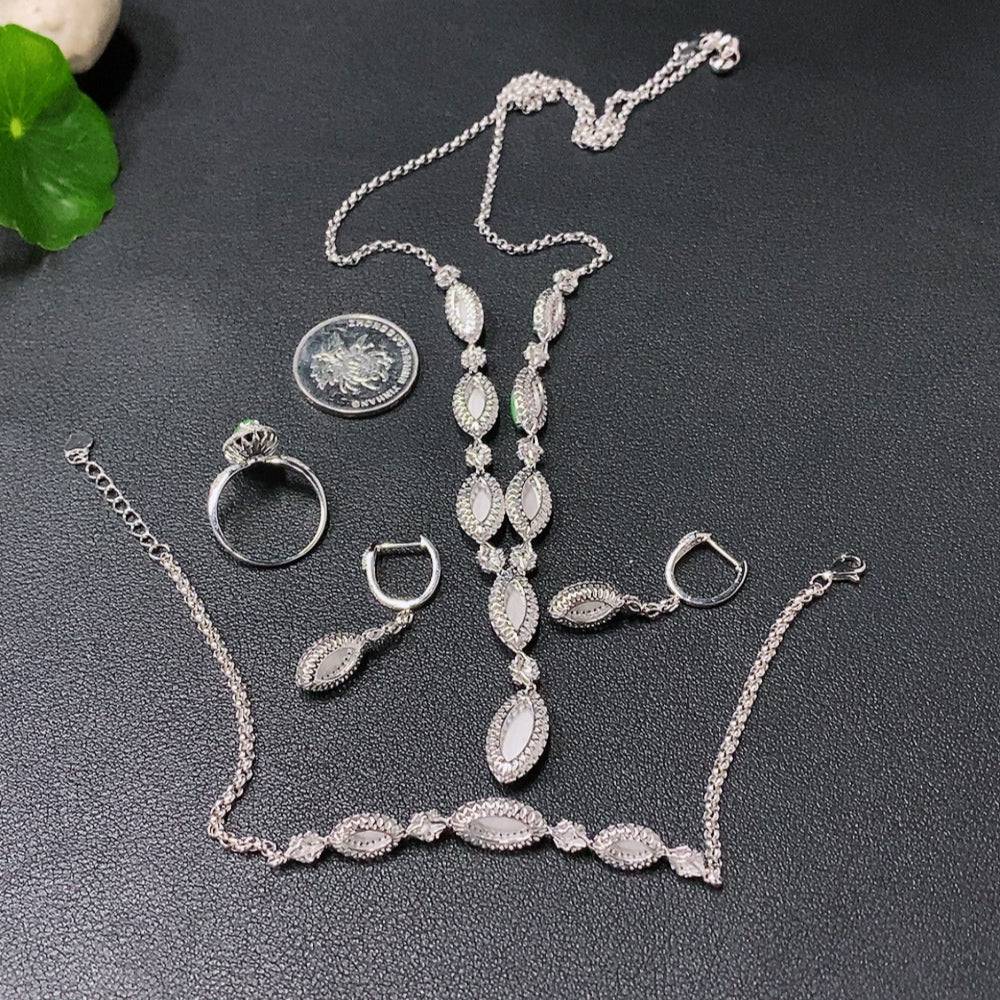 Jadeite inlaid jewelry set with necklace, bracelet, earrings, and ring in 18k gold with diamond accents, total weight 23.5g.
