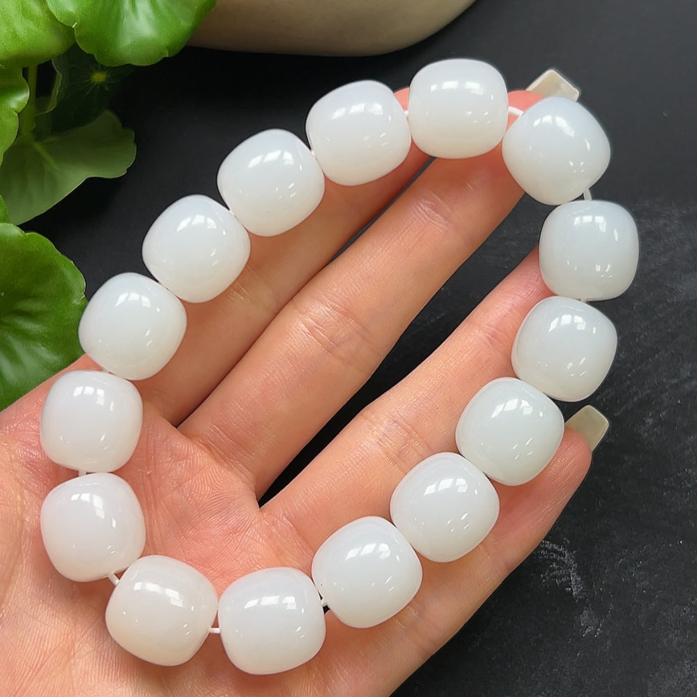 Elegant Hetian jade bracelet from HKHQ featuring smooth, polished jade beads with a natural green hue and intricate clasp design.