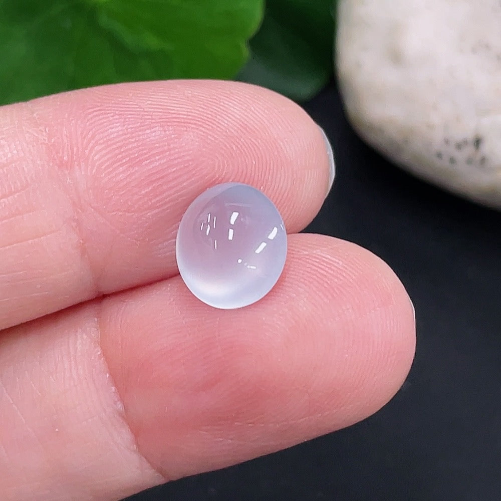 Jadeite cabochon from HUILIU HQ, approximately 0.6g, showcasing smooth, polished green jade with a rounded surface.