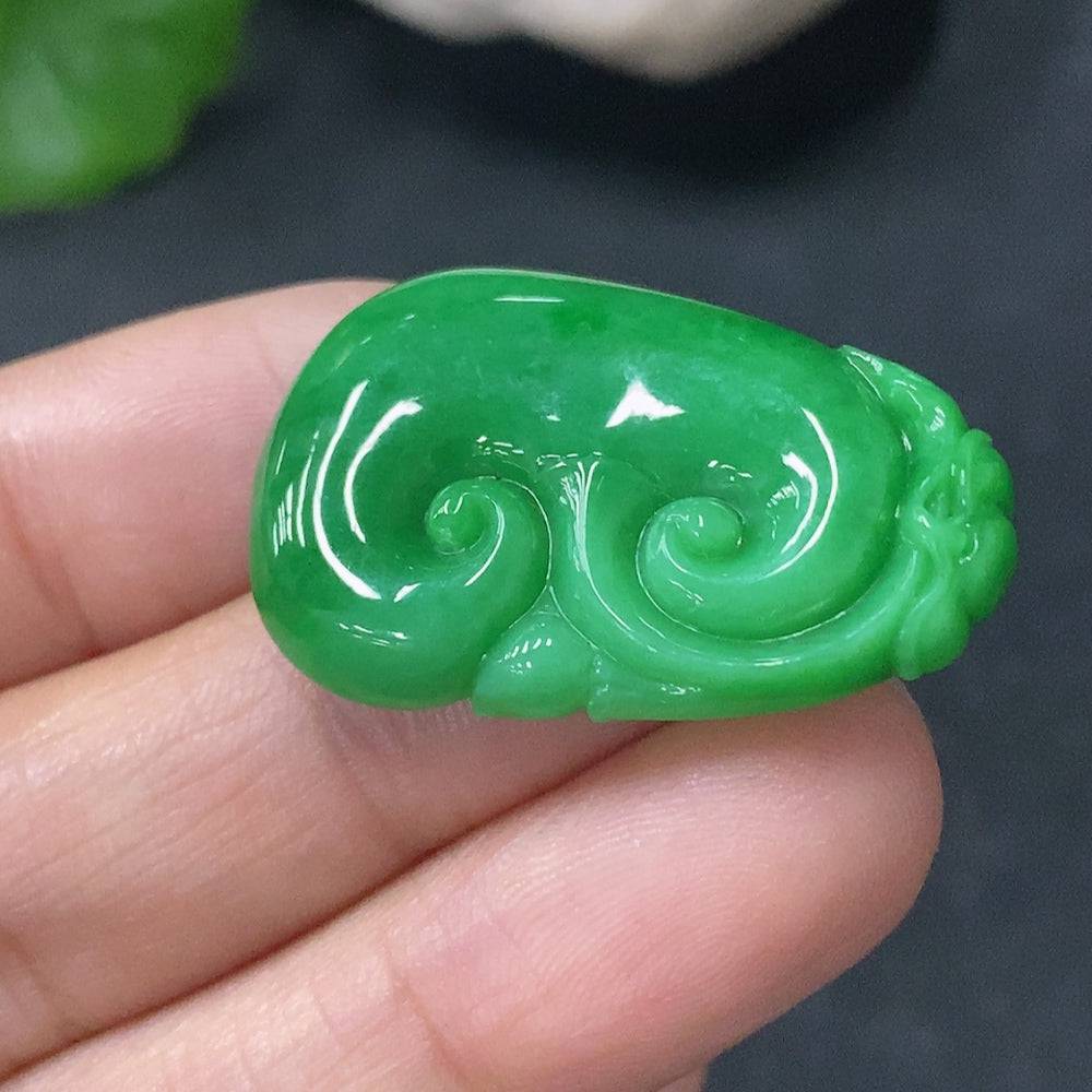 Huiliu Jadeite Pendant Ruyi with intricate carved design, showcasing smooth, polished jade in vibrant green hues.