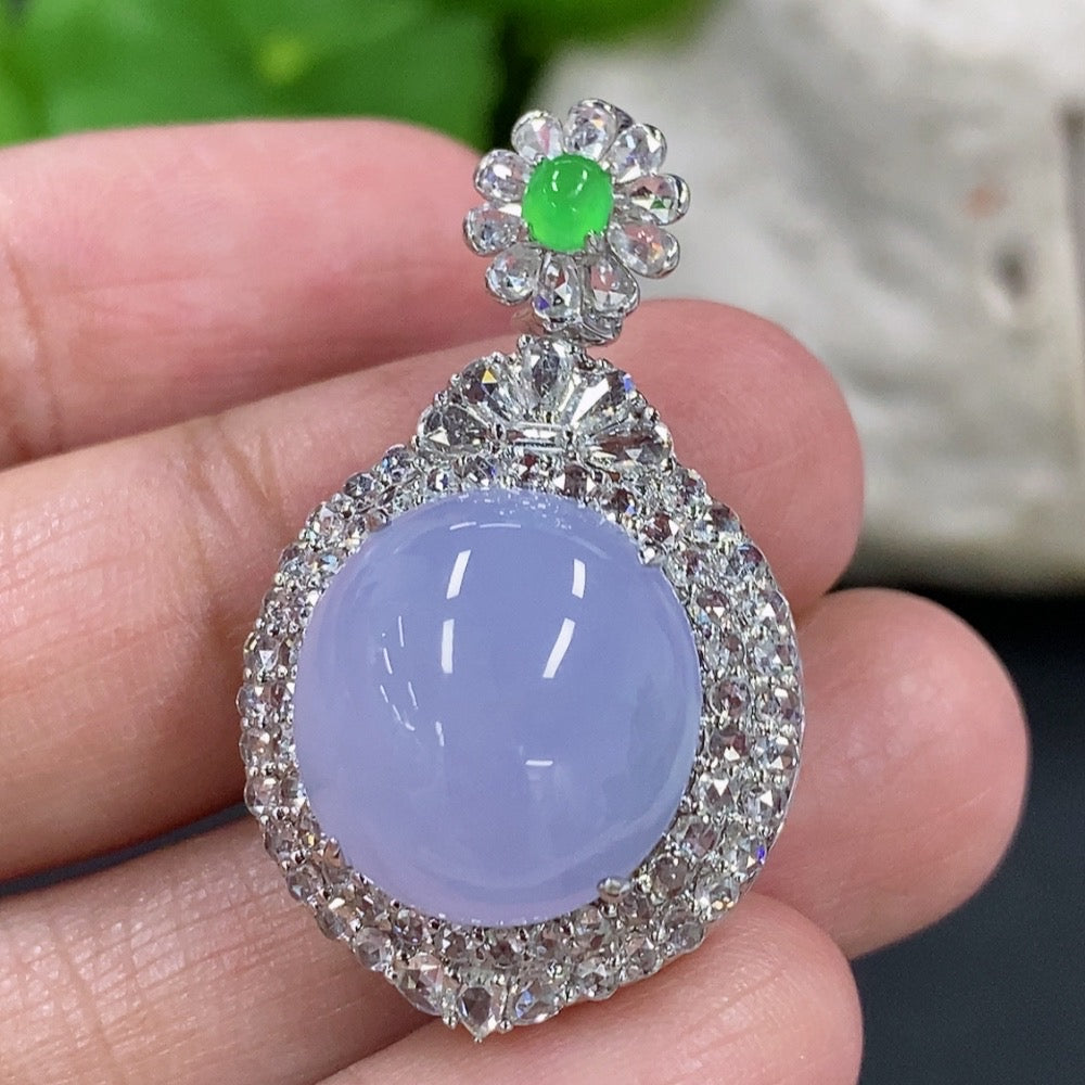 Jadeite cabochon pendant with 18K gold setting and diamond accents, elegant necklace showcasing a polished green gemstone.