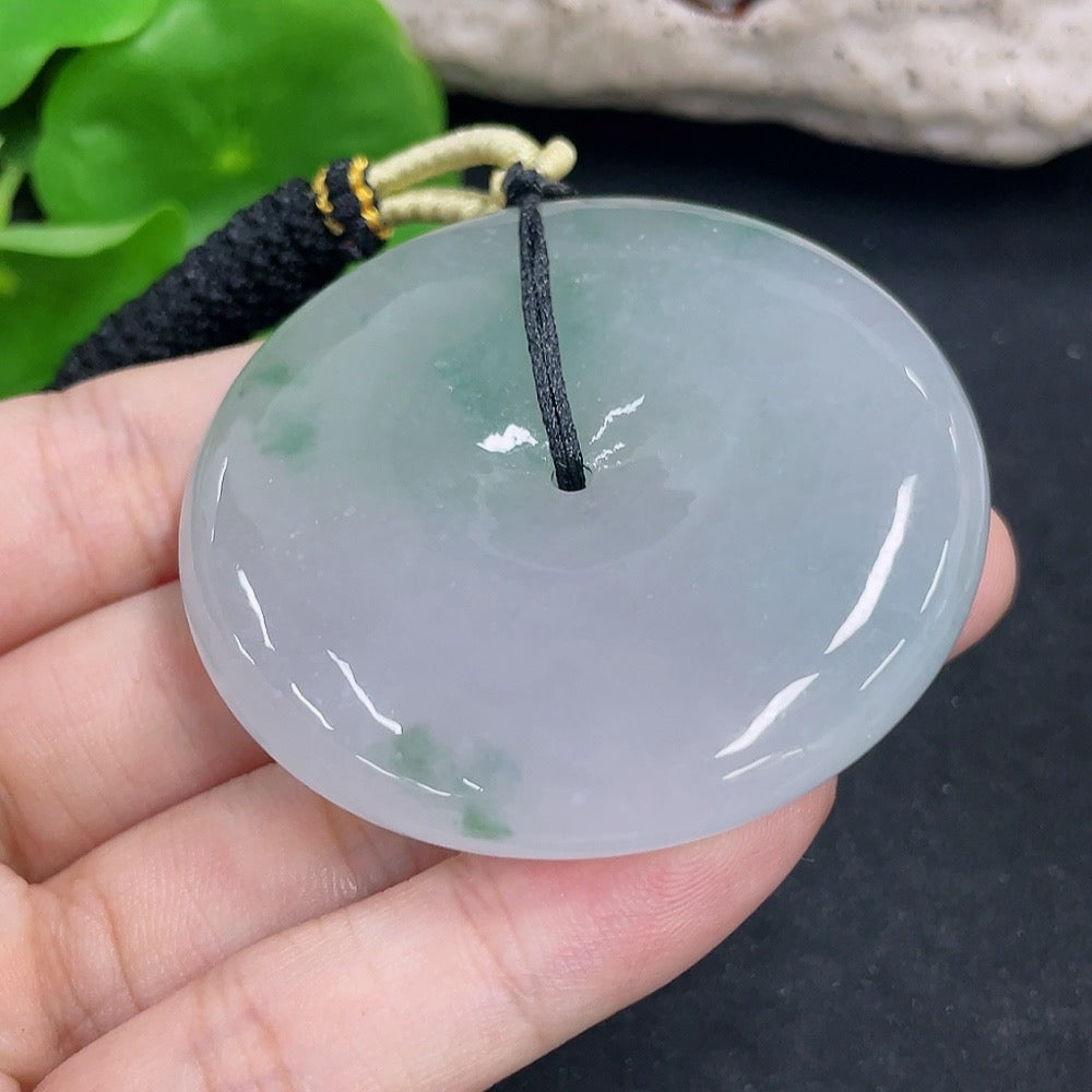 Jadeite Peace Knot pendant on a necklace, handcrafted jewelry with a smooth, polished green jadeite stone, weighs approximately 60.16g.