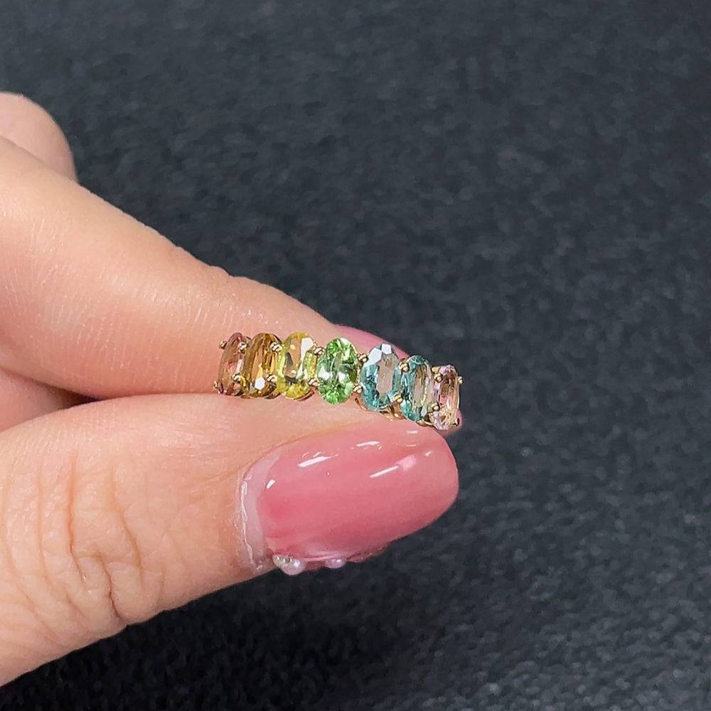 Huiliu certified gemstone tourmaline ring featuring vibrant, multicolored stones in a polished silver band.