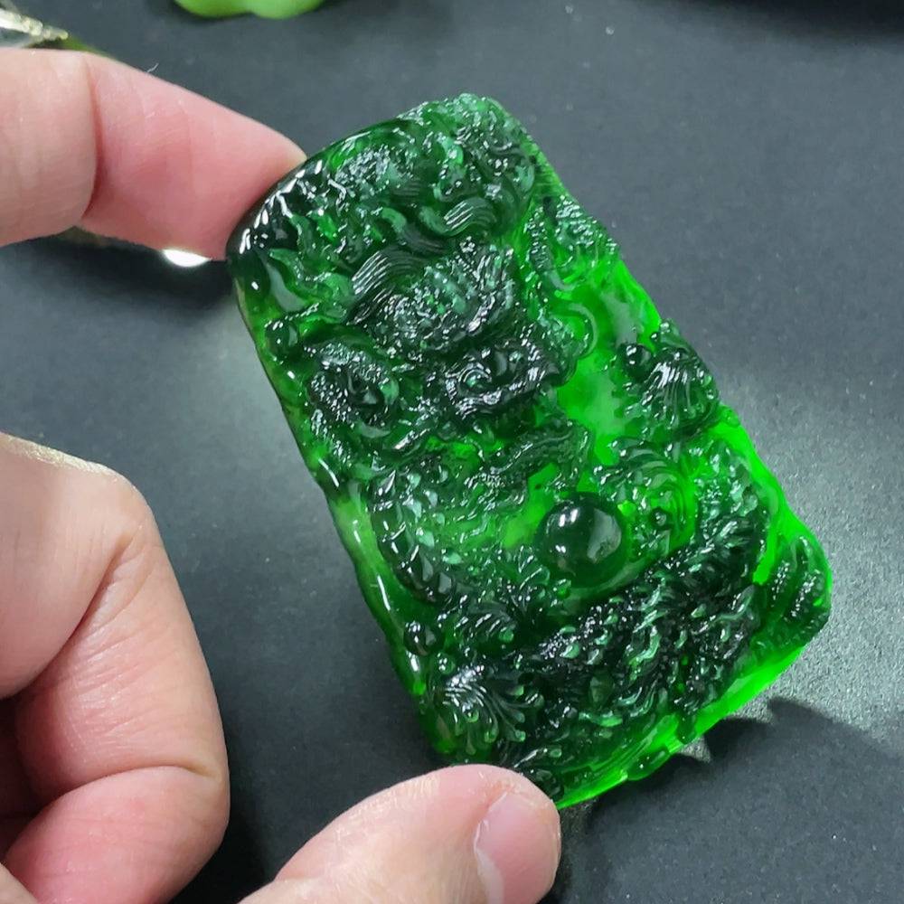 Jadeite dragon pendant weighing approximately 40g, crafted from green jade, showcasing detailed dragon design and smooth polished surface.