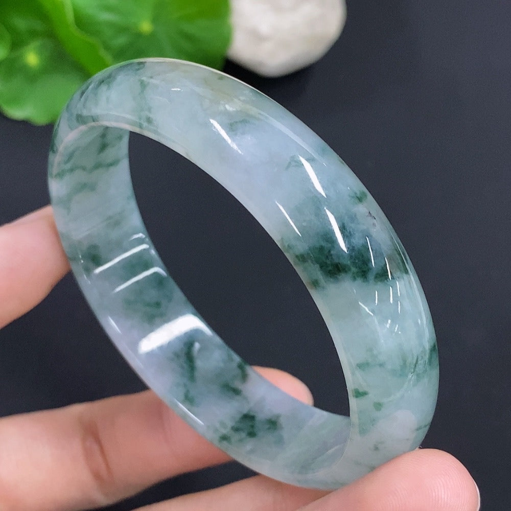 HKHQ jadeite oval bangle in size 58.8 with 47.7g, showcasing smooth, polished green jadeite bracelet on a neutral background.