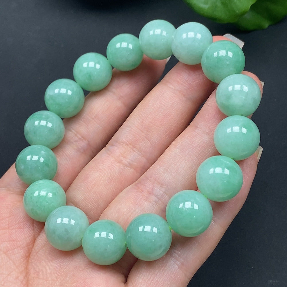 Jadeite bracelet by HKHQ with 12.8-inch size, featuring polished jadeite beads, weighing approximately 57.85g.