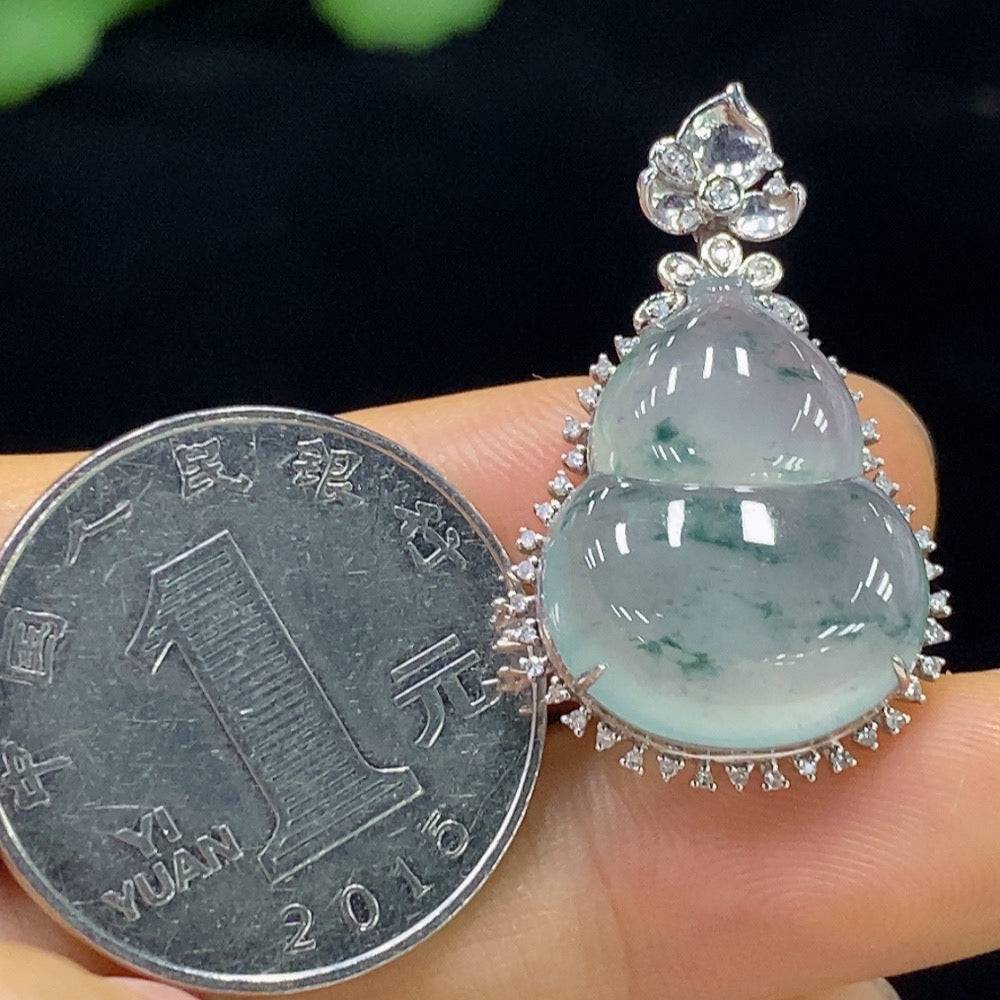 Jadeite gourd pendant with 18K gold and diamond inlays, featuring intricate craftsmanship and a polished finish.