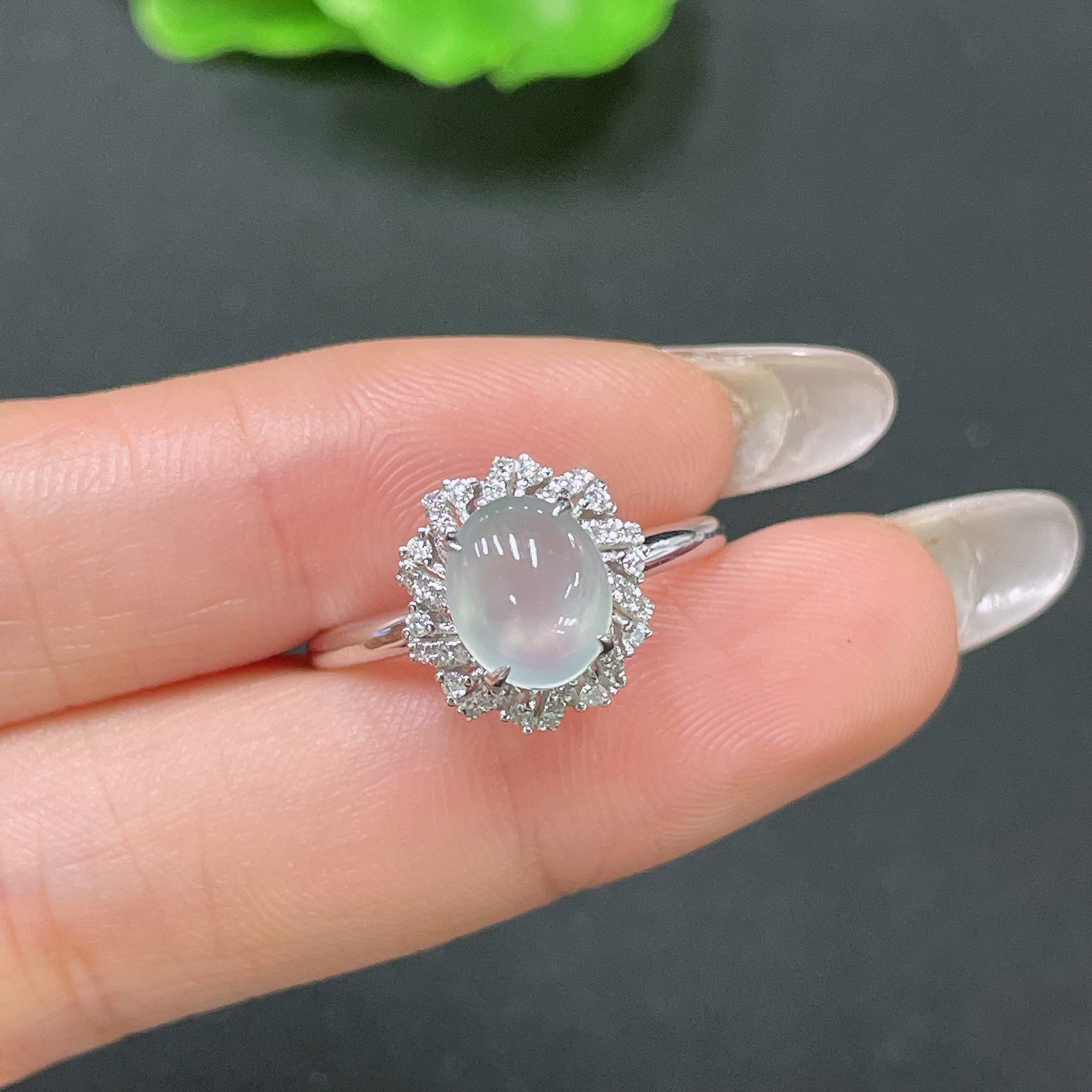 Jadeite ring with 18k gold setting and diamond accent, size 18, featuring a polished green jade stone and elegant gold band.