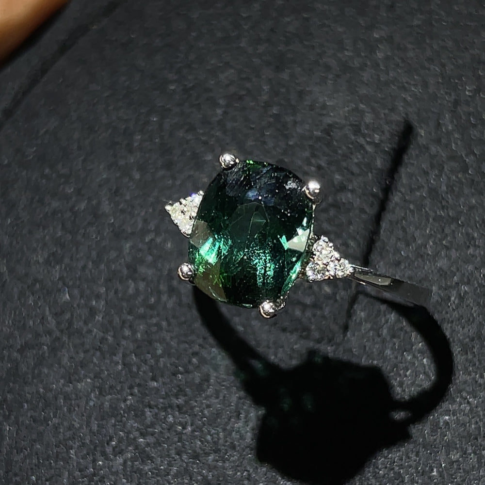 HKHQ tourmaline ring with gold setting and diamond accents, showcasing a vibrant gemstone and elegant jewelry design.