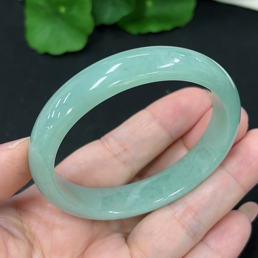 HKHQ jadeite oval bangle in size 53.2 with a weight of 37.4g, showcasing its smooth, polished surface and elegant oval shape.