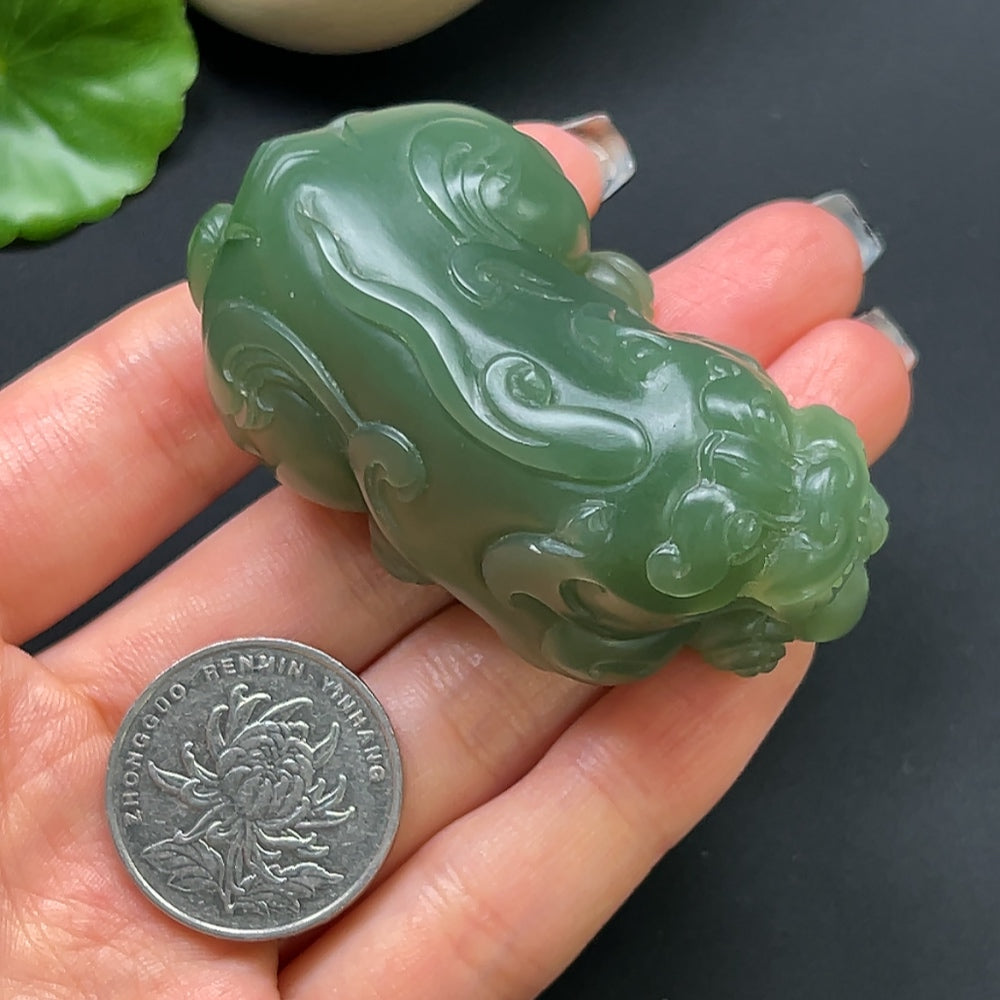 Hetian Jade Pixiu pendant necklace with intricate carvings, featuring a polished jade piece on a delicate chain.
