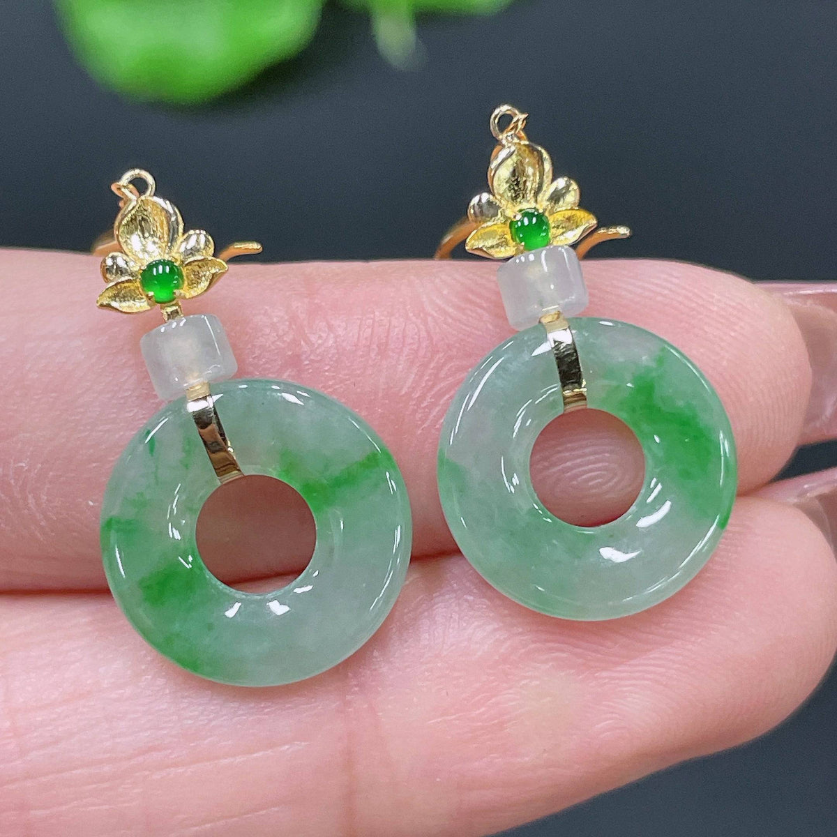 Huiliu Certified Jadeite earrings featuring smooth, polished green jade stones in elegant drop design.