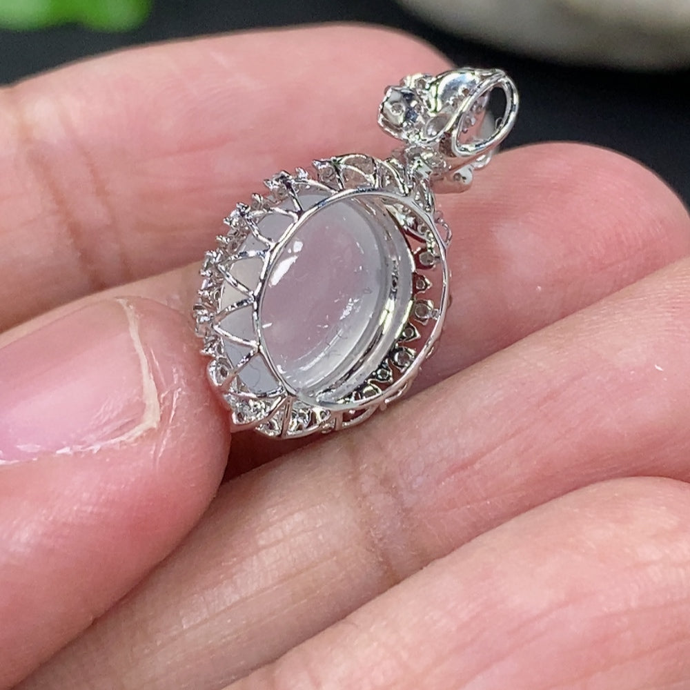 Jadeite cabochon pendant with 18K gold setting and diamond accents, featuring a smooth green jade stone and delicate gold details.