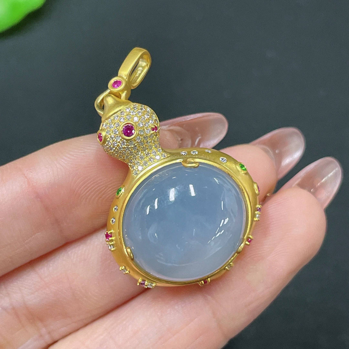 HUILIU HQ jadeite pendant with 18k gold setting and colorless diamond accents, showcasing a smooth, polished jade stone.