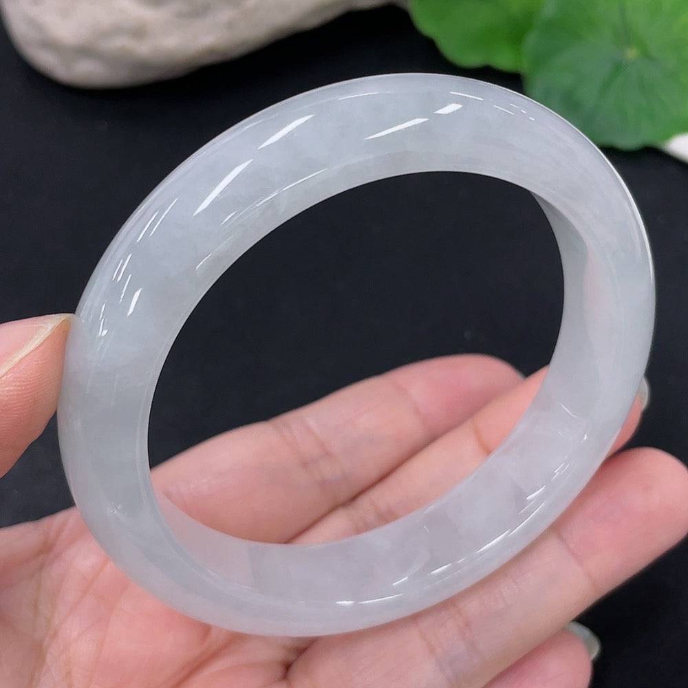 Huiliu Certified Jadeite round bangle showcasing smooth, polished green jade with natural variations and a glossy finish.
